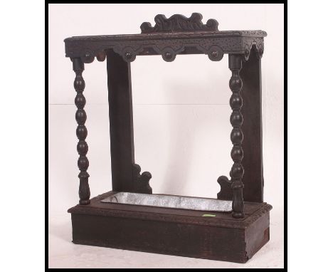 A Victorian Jacobean revival oak stick stand having twin drawers with carved frame and gallery back. H80 x W62 x D26cm 