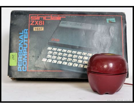 A vintage ZX81 Spectrum home computer in the original box. Together with a retro novelty telephone in the form of an apple