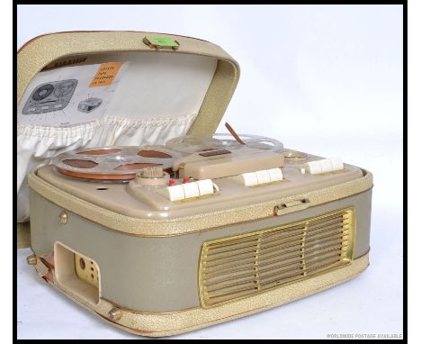 A vintage cased reel to reel cassette player recorder, having carry handle atop with compartments for leads and microphone