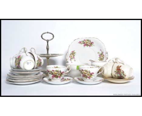 A vintage Chintz pattern Staffordshire tea service comprising cups, saucers plates etc. Together with an unassociated cake pl