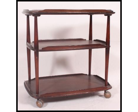 A retro 1970's Ercol 3 tier butlers serving trolley. Beech and elm wood with gallery sides to the tiers on original castors. 
