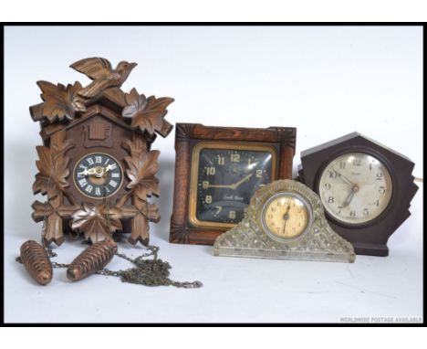 A collection of clocks to include a cuckoo clock, Bakelite Ferranti, Smiths black faced alarm clock in oak frame etc. H23cm 