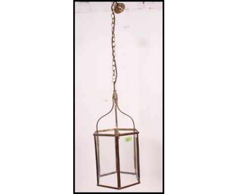 A contemporary but vintage style brass and glass hanging ceiling lamp