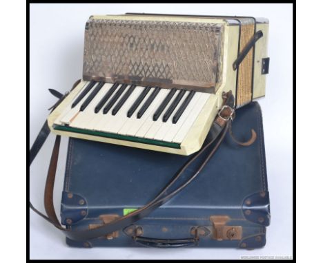 A cased vintage Hohner Alpina Accordion complete with the original case