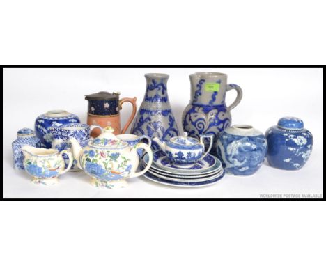 A collection of blue and white ceramics to include willow pattern teapot, G Jones Abbey pattern creamer, Masons Regency teapo