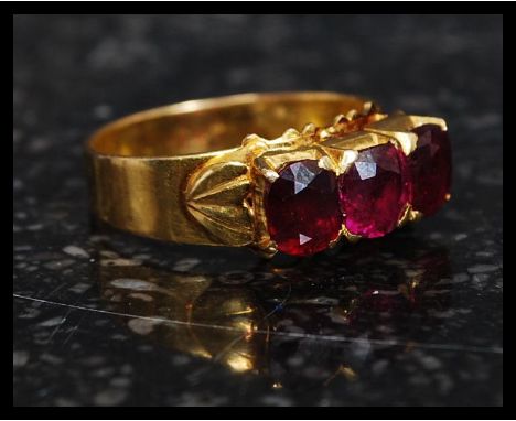 A stunning 22ct gold ( high carat ) 3 stone ruby ring.  The 3 central ruby stones over 1ct ( 2 x 50pnt & 1 x 25pnt ) being ro