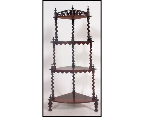 A Victorian mahogany corner shelf whatnot, three tier with pierced gallery back rail to top and turned wooden spindle support