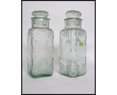 A pair of vintage pressed glass sweet jars, both retaining original lids