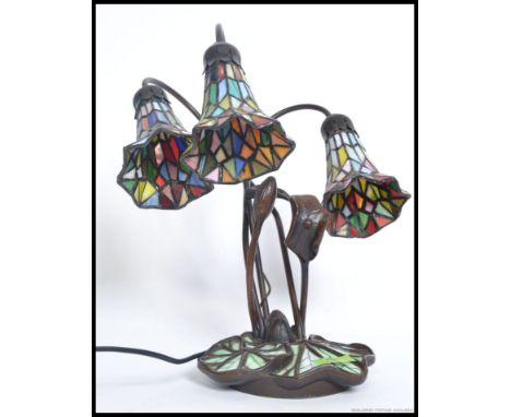A 20th century Tiffany style lamp having decorative base with stained glass half moon shade. H45 cm