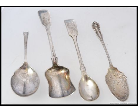 A collection of four silver hallmarked spoons - A shovel shaped caddy Exeter 1851 - makers mark J.S - John Stone - Length 14.