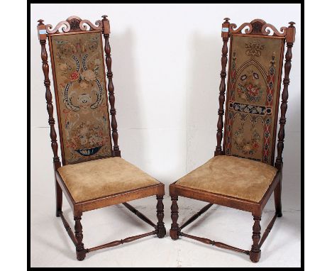 An excellent pair of Carolean design walnut high back chairs. The tall back rests with tapestry upholstered centres and seats