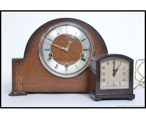 A mid century Smiths oak cased mantle clock along with a smaller Smiths Bakelite electric clock. H23cm 