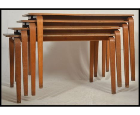 A stack of vintage 20th century stacking school desks. The legs of bentwood form having blue vinyl covered tops to each.  Mea