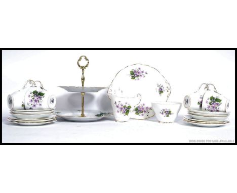 A Regency chintz pattern part tea service comprising cups, saucers, plates etc. Together with an un-associated cake stand