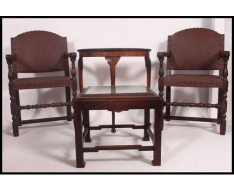 A pair of 1920's Jacobean revival carver armchairs with leatherette covers together with a Chinese side table and a demi lune