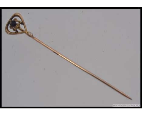 A 14ct gold and amethyst set ladies stick pin. The central stone being claw mounted. Stick marked with initials JHK. Total we