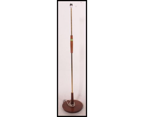 A 20th century retro teak and metal standard lamp having teak circular base with sectional column,