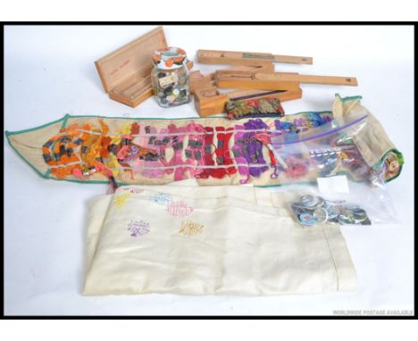 A collection of vintage sewing equipment in roll up case together with buttons. Also vintage badge collection together with v