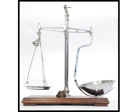 An early 20th century chrome and wooden plinth mounted pair of snuff scales by Avery. Complete with weights H46cm