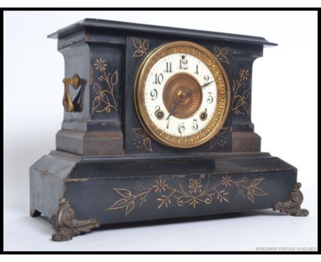 An Ansonia black metal mantel clock striking on a gong having decorative facia. The 8 day movement marked for Ansonia. H77 x 