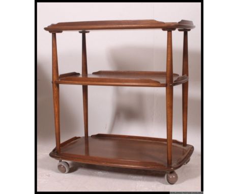 A vintage retro Ercol tea trolley, twin tiers with raised gallery sides on 4x castors.  Measures: 72 x 68 x 45cm.