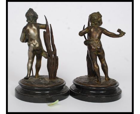A pair of late 19th / early 20th century spelter bronzed figures on a marble base. Each depicting cherubs / children hunting,