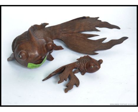 Two vintage carved wooden Chinese figures of fish, one large, one small. Both with inset glass eyes. L23cm 