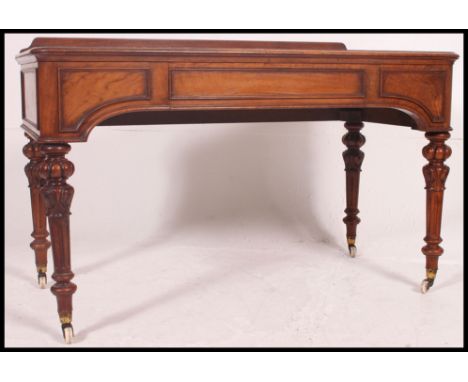 A mid 19th century Victorian / Regency mahogany writing table in the manner of Gillows. Stunning reeded tapered legs with det