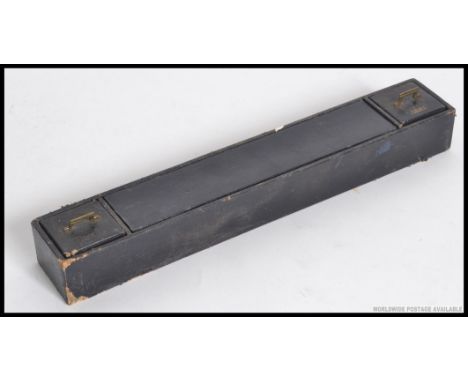 A black leather cased travelling writing set, having a ink well to one end and an oil light to the other end with a central r