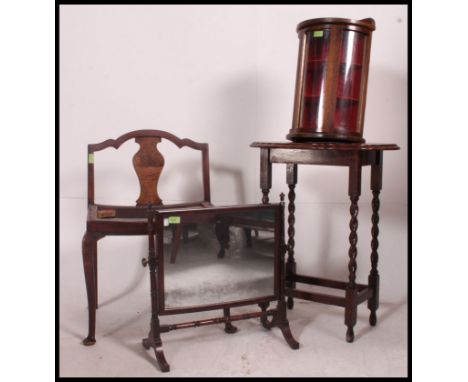 A Victorian mahogany toilet swing mirror together with a barleytwist oak lamp table, oval glass small display cabinet and a Q