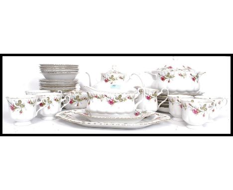 A 20th century Chinese chintz pattern part tea service to include cups, plates, tureens etc. Of polish original being stamped