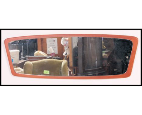 A vintage 1970's oval teak wall mirror. The frameless mirror glass with oval lozenge shaped back panel.W56 x D40cm