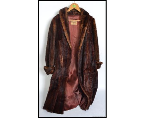 A vintage mid century ladies fur coat with lined interior bearing original labels for M Michaels of Taunton