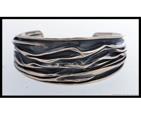 A contemporary decorative ladies bangle bracelet in the manner of Georg Jensen. Scottish modern hallmarks possibly  1977 make
