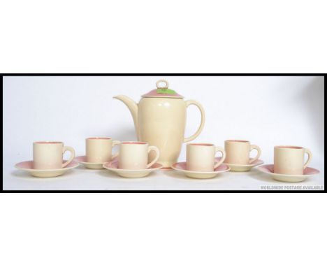 An early 20th century Susie Cooper coffee service in the Kestrel shape to include six coffee cans, six saucers and matching c