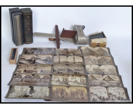 A vintage stereo viewer together with over 40 stereoscopic cards, lantern slides etc