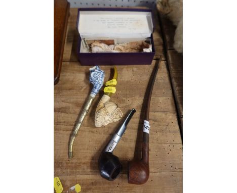 A delft elephant&nbsp; mask pipe, a Meerschaum style pipe,&nbsp; a church wardens pipe and a pipe with silver mounts