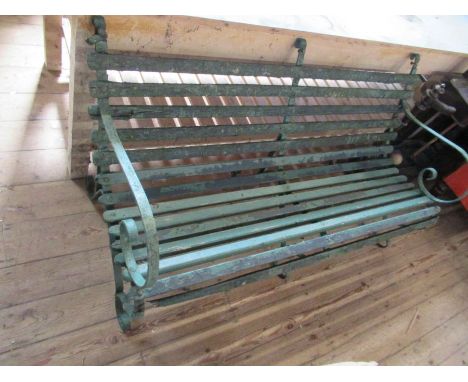 A garden bench, with wrought iron scroll ends and slats, length 57ins