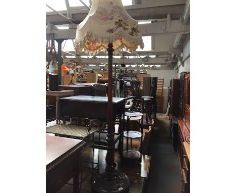 A carved and stained beech lamp standard. 
