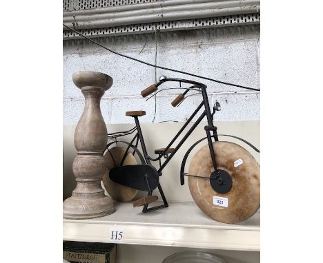 A model bicycle and a wooden candlestick 