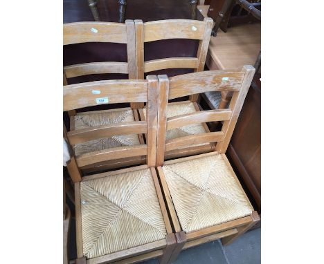 A set of four light wood rush seated ladder back chairs. 