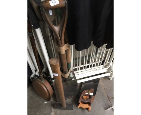 Various garden tools comprising four hand saws, a sledge hammer, two shovels and two forks. 