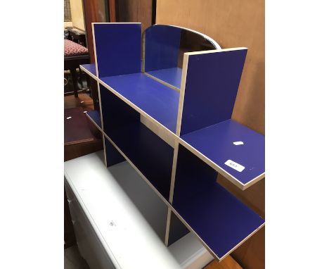 A blue wall shelf unit 