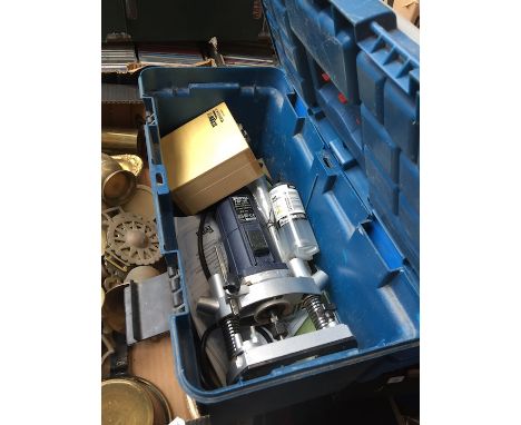 A toolbox with a router and other bits 