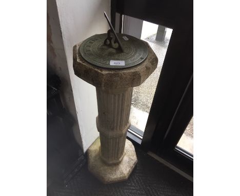 A garden sundial on concrete column. 