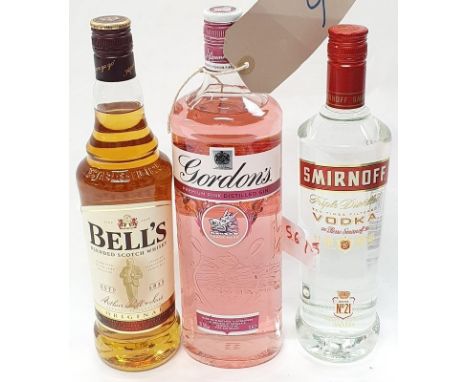 Three bottles of alcohol: 1L Gordons Pink gin, 70cl Smirnoff Vodka and 70cl Bells Scotch whiskey (Ref 6/56). 