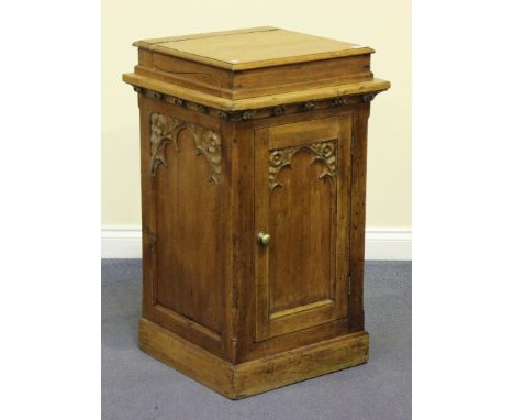 A 20th century Continental pine wash stand, the hinged lid revealing a ceramic bowl above a carved panel door, on a plinth ba