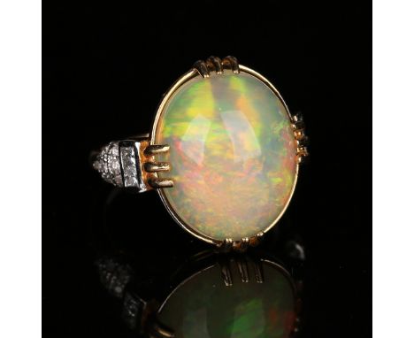 An 18ct gold, opal and diamond ring, claw set with an oval opal between diamond set shoulders, detailed '18ct', ring size app