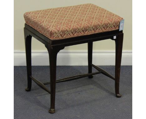 An early 20th century George III style mahogany stool, the seat upholstered in a red and gilt patterned damask, raised on tap
