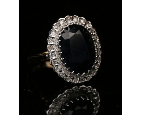 A 9ct gold, sapphire and diamond oval cluster ring, mounted with the oval cut sapphire within a surround of circular cut diam